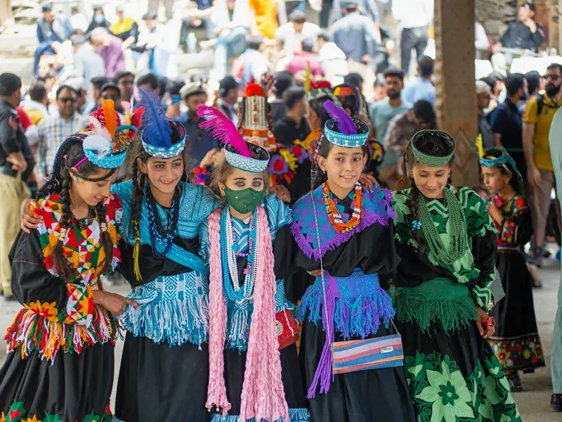 Kalasha women in traditional dress during a festival, Bumburet Valley, Chitral